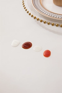 Detail of waterproof PVC tablecloth showing thick colorful liquid droplets on its surface