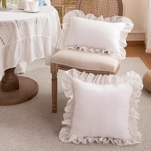 White French ruffle embroidered cotton pillowcase set in a cozy rustic interior