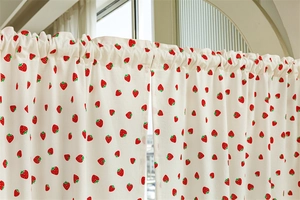 Detail of cotton rod pocket cafe curtain with vibrant red strawberry prints
