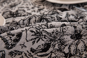 Macro detail of vintage jacquard tablecloth with black and white butterfly patterns