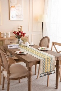 Close-up of yellow and blue wave pattern table runner with elegant tassels