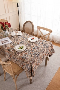 Close-up of vintage thick jacquard tablecloth with floral bird patterns and tassel fringe