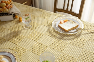 Vue détaillée de la nappe en jacquard géométrique jaune et blanc à motif de grille