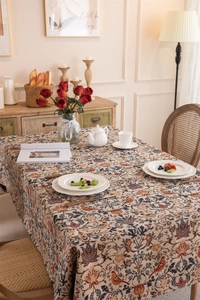 Detailed close-up of vintage floral and bird jacquard patterns on high-quality table cloth