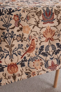 Close-up of vintage jacquard fabric with birds and floral patterns for dining table decor