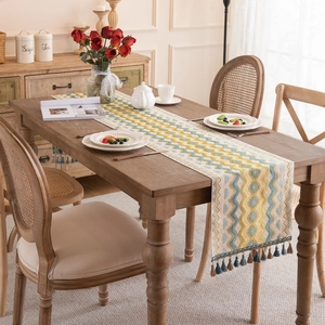 Modern jacquard table runner with blue and yellow waves and decorative tassels