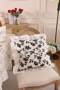 Detail of French floral tablecloth with elegant ruffles and vintage botanical print pattern