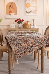 Detailed view of American retro tablecloth with jacquard birds, flowers and beige tassels