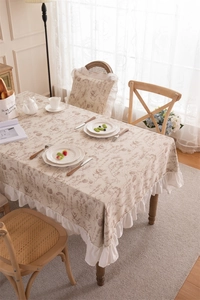 Detail of floral polyester tablecloth featuring ruffles and vintage botanical patterns
