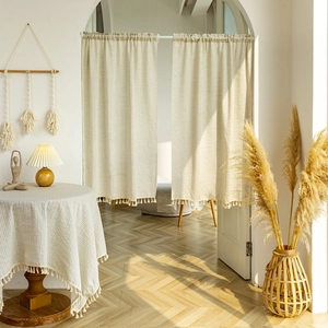 Beige cotton linen cafe curtains with tassel trim and matching tablecloth in room setting