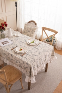 Close-up of floral print tablecloth with white ruffled edges in French country style