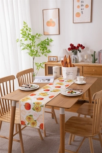 Detailed close-up of autumn pumpkin and sunflower digital print on harvest table runner