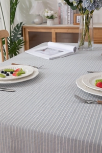 Close-up of blue and white striped cotton tablecloth texture on a dining table
