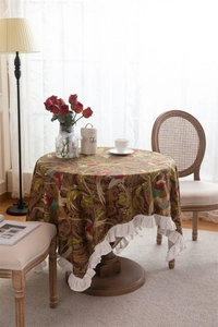 Detail of vintage cotton canvas tablecloth with bird floral pattern and ruffled edges