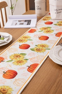 Detail of harvest pumpkin sunflower table runner with high-quality fabric texture