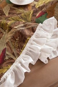 Detail of vintage cotton canvas tablecloth with phoenix prints and ruffled edges