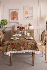 Detail of vintage cotton canvas tablecloth with bird floral pattern and ruffled edges