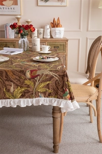 Detail of vintage floral cotton canvas tablecloth with elegant ruffled white edges