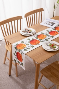 Close-up of harvest pumpkin and green vine print on a premium waterproof fabric table runner
