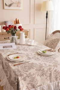 Close-up of vintage floral tablecloth featuring elegant double-layered ruffled edges