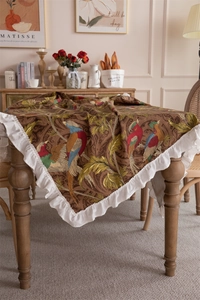 Detail of vintage floral cotton canvas tablecloth with white ruffled edges for round tables