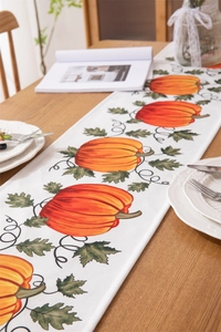 Detail showing high-quality waterproof fabric texture and vivid pumpkin print on table runner