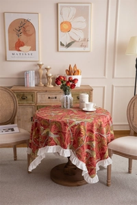 Detail of vintage floral cotton tablecloth with ruffled edges and bird patterns