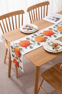 Macro view of pumpkin print detail on white harvest thanksgiving table runner