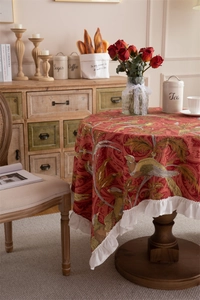 Detail of vintage floral cotton tablecloth showing ruffled edges and pheasant pattern