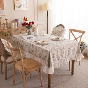 French style floral tablecloth with ruffle edges on a wooden dining table in a cozy room