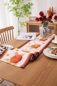 Detailed view of fall harvest pumpkin table runner with autumn maple leaf pattern