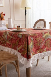 Close-up of vintage cotton canvas tablecloth with ruffles and floral bird pattern
