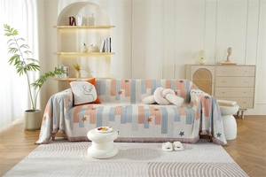 Close-up of Nordic chenille sofa cover with star patterns and elegant fringe trim