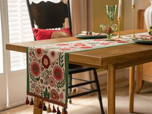 Detailed close-up of retro jacquard table runner with floral pattern and tassels