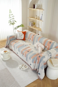 Detail of chenille sofa cover featuring star patterns, colorful stripes and fringe edges