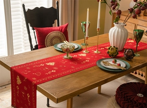 Detail of red festive table runner with golden jacquard lanterns and Fu patterns