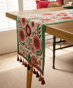 Close-up of American retro table runner with floral jacquard and colorful tassels