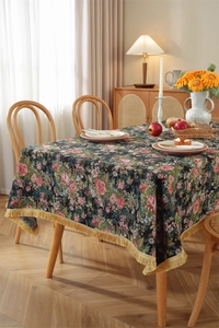 Close-up of vintage floral jacquard tablecloth with elegant golden fringe tassel edges