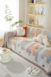 Detail of chenille sofa cover showing vertical stripes, star patterns and fringe edges