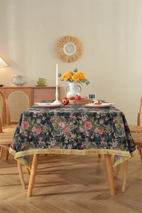 Detail of vintage floral tablecloth with red roses and elegant gold fringe tassels