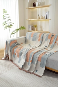 Detail of Nordic chenille sofa throw with star patterns, stripes and colorful fringe