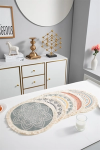Détail de sets de table ronds boho avec motifs mandala et bordures à franges