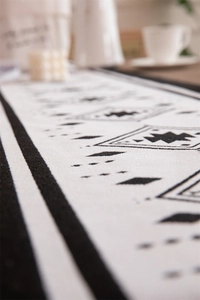Close-up of black and white checkered table runner with geometric woven texture