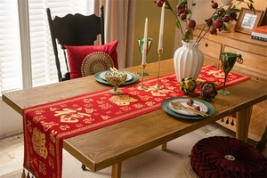 Close-up of red Chinese New Year table runner with gold Fu characters and silk tassels