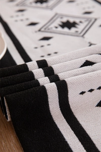 Close-up of geometric diamond weave pattern on thick monochrome jacquard table runner
