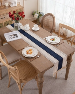 Detail of bohemian woven table runner with blue stripes, hollow crochet, and fringe tassels