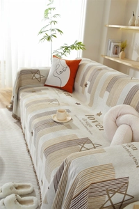 Close-up of Chenille sofa cover featuring woven star patterns and tassel edge details