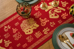 Detail of red Chinese New Year table runner featuring golden Fu character and dragon motifs
