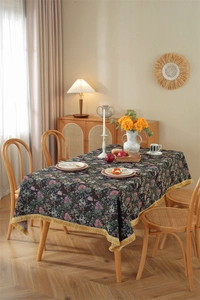 Close-up of vintage floral jacquard tablecloth with thick texture and gold fringe detail