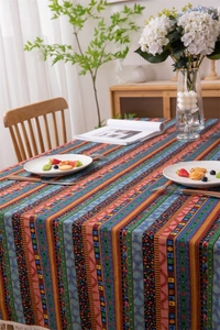 Detail of bohemian striped tablecloth with intricate patterns and cream fringe tassels